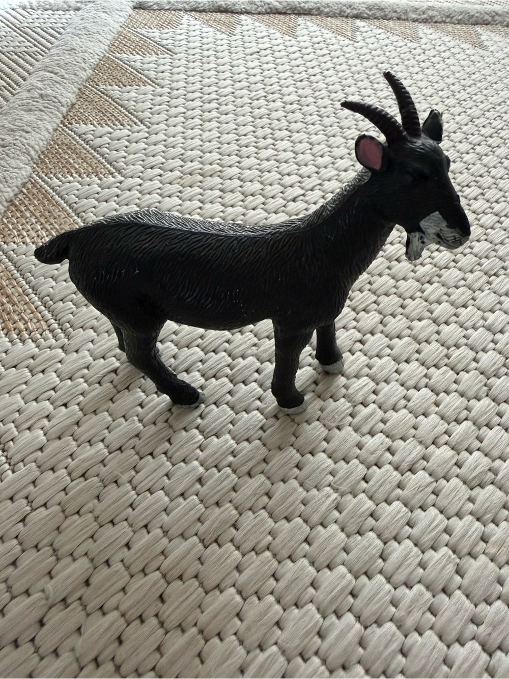 Black goat figurine with textured fur and white hooves #animal #collectible